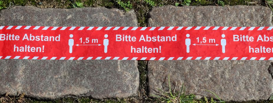 Bitte Abstand Halten! 1.5 meter social distancing sign for COVID-19. Keep distance symbol in german language