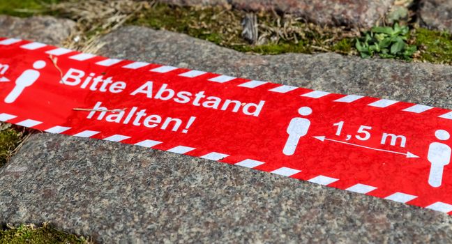 Bitte Abstand Halten! 1.5 meter social distancing sign for COVID-19. Keep distance symbol in german language