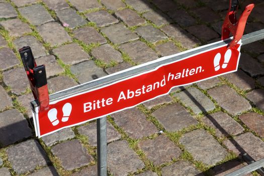 Bitte Abstand Halten! 1.5 meter social distancing sign for COVID-19. Keep distance symbol in german language