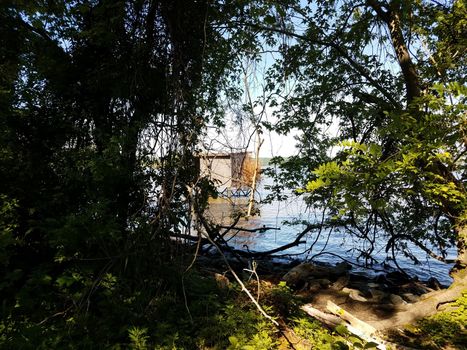 bird watching or fishing structure blind in water with trees