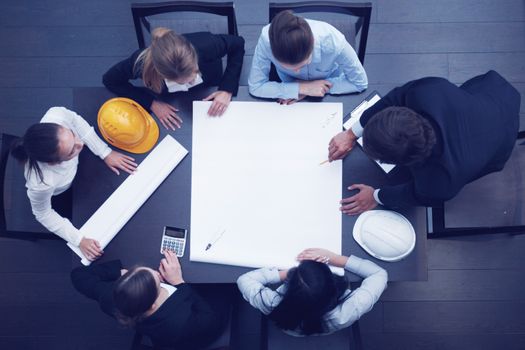 Top view of people around table in construction business meeting