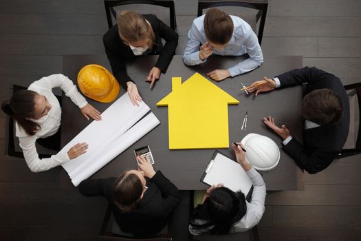 Top view of people around table in construction business meeting