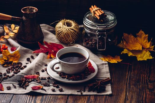 Cup of turkish coffee with spices on tablecloth