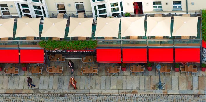 DRESDEN, GERMANY - SEPTEMBER 22, 2014: Top down view on street of Dresden, state of Saxony, Germany, Europe. Restaurant and people down below.