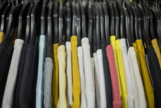 T shirts lined in a row on rack