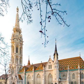 Old town architecture of Budapest. Buda temple church of Matthias. Buda's Castle District. Blue cloudy sky in background. Hungary, Europe.