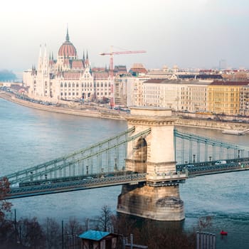 Parliament building and Chain Bridge in Budapest, Hungary, Europe. Blue water of Danube river. Major Landmark and tourist attraction.