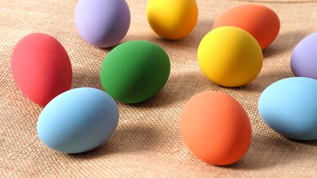 Multi-colorful of easter eggs on background in studio with close-up shot which include many colour such as yellow, green, blue, purple, red covered on eggs by art painting