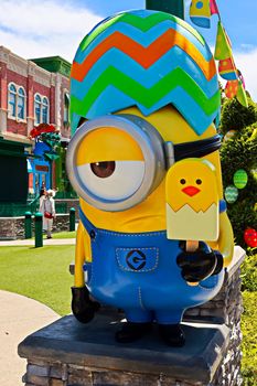 OSAKA, JAPAN - June 17, 2020 : Statue of HAPPY MINION easter version in Universal Studios Japan.Minions are famous character from Despicable Me animation.Universal Studios Japan reopening after COVID-19 quarantine.