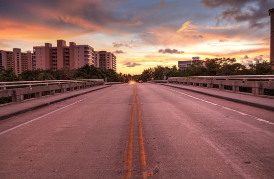 Middle of the road Overpass on Bluebill Avenue leading toward Delnor Wiggins State Park at sunset in Naples, Florida.