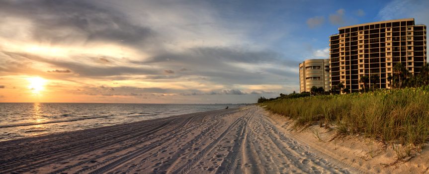 Sunset over white sand at Delnor Wiggins State Park in Naples, Florida.