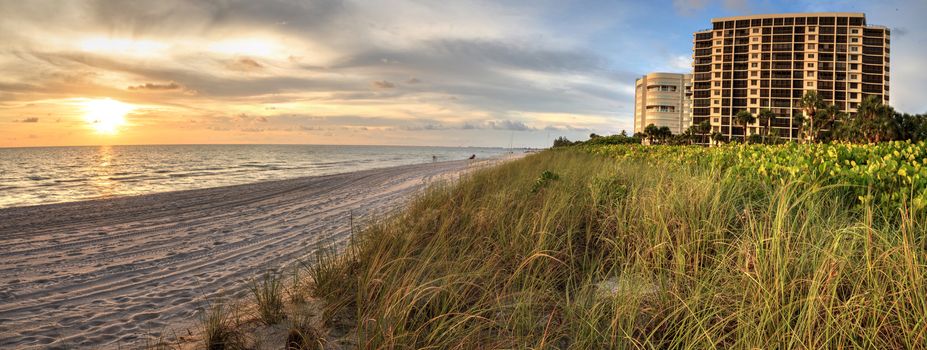 Sunset over white sand at Delnor Wiggins State Park in Naples, Florida.