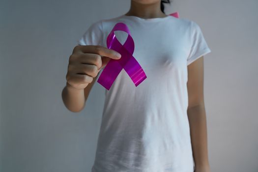 A woman with a pink ribbon on breast cancer awareness Concept of health care and medicine.