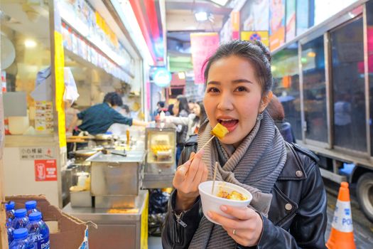 Chinese Asian young female model eating Chinese Steamed Dumpling