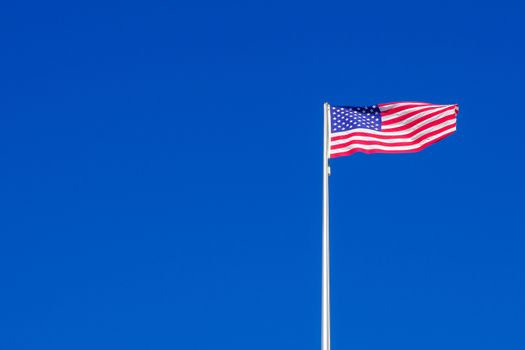 American flag on the blue sky