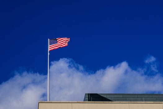 American flag on the blue sky