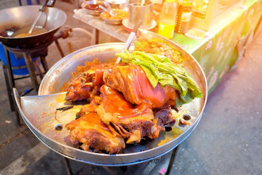 Stewed pork legs and  vegetable on steaming pot street food in Thailand market.