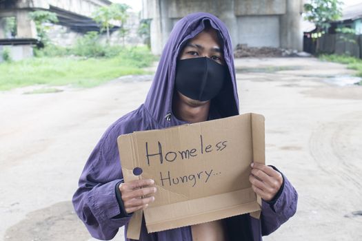 Unhappy homeless man under the bridge