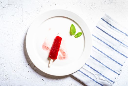 Delicious strawberry popsicles on light background