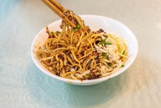 LiangMian cold noodles chinese dish with chopsticks close-up view
