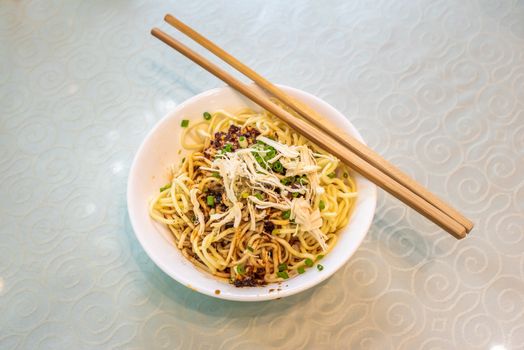LiangMian cold noodles chinese dish with chopsticks close-up view