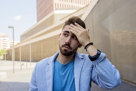 Young bearded man, model of fashion, in urban background wearing casual clothes.