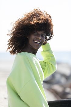 Portrait of a beautiful afro american woman standing in the street in a sunny day