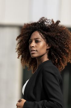 Portrait of a beautiful afro american woman standing in the street in a sunny day