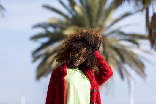 Portrait of a beautiful afro american woman standing in the street in a sunny day