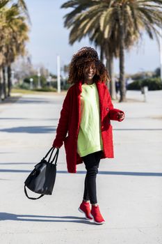 Portrait of a beautiful afro american woman standing in the street in a sunny day