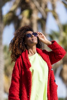 Portrait of a beautiful afro american woman standing in the street in a sunny day