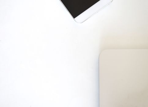 Above view of communicators device on desk, mobile phone and laptop