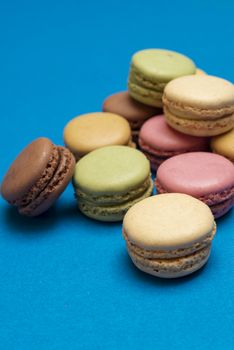 Colorful macaroons over a colored bakcground