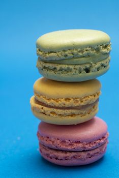 Colorful macaroons over a colored bakcground