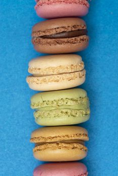 Colorful macaroons over a colored bakcground