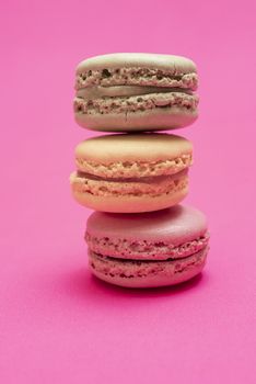 Colorful macaroons over a pink bakcground