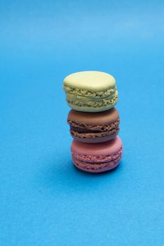 Colorful macaroons over a colored bakcground