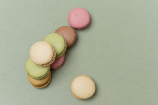 Macaroons on green background from above