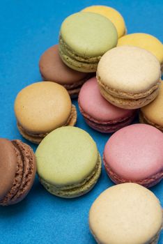 Colorful macaroons over a colored bakcground