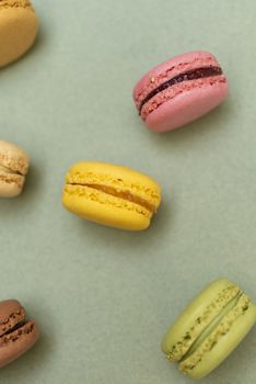 Macaroons on green background from above