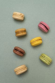 Macaroons on green background from above