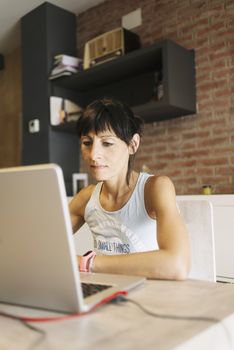 Woman with laptop working at home