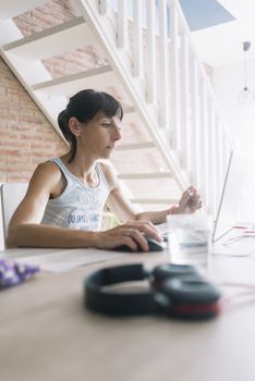 Woman with laptop working at home