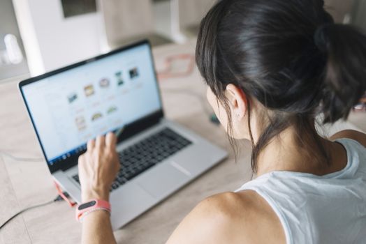 Woman with laptop working at home