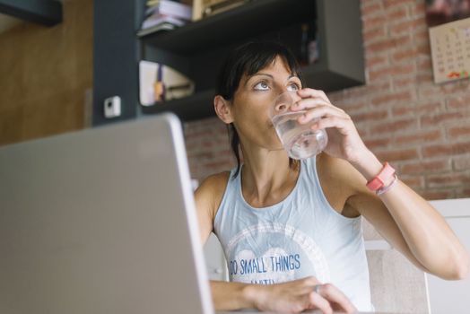 Woman with laptop working at home