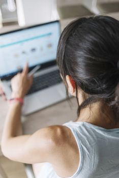 Woman with laptop working at home