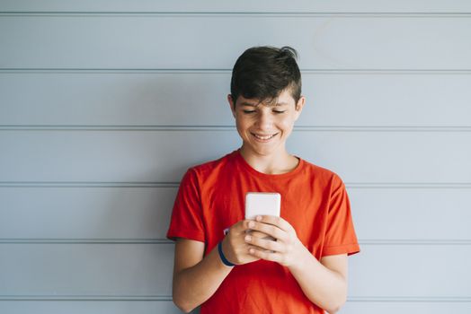 Profile of a happy guy texting on a smart phone