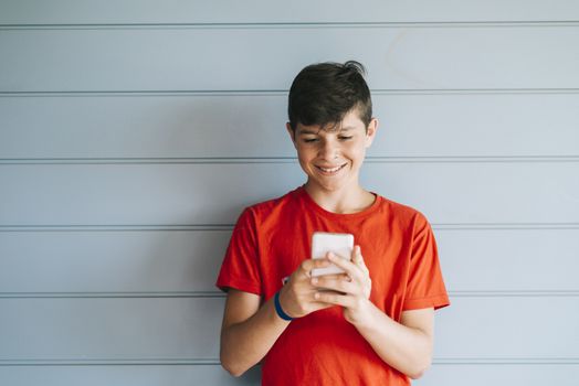 Profile of a happy guy texting on a smart phone