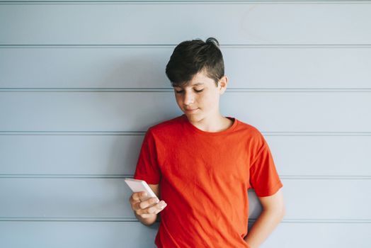 Profile of a happy guy texting on a smart phone