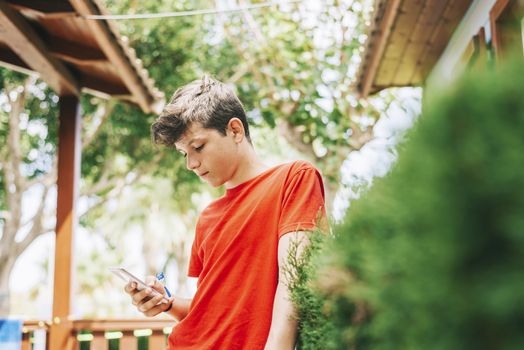 Profile of a happy guy texting on a smart phone
